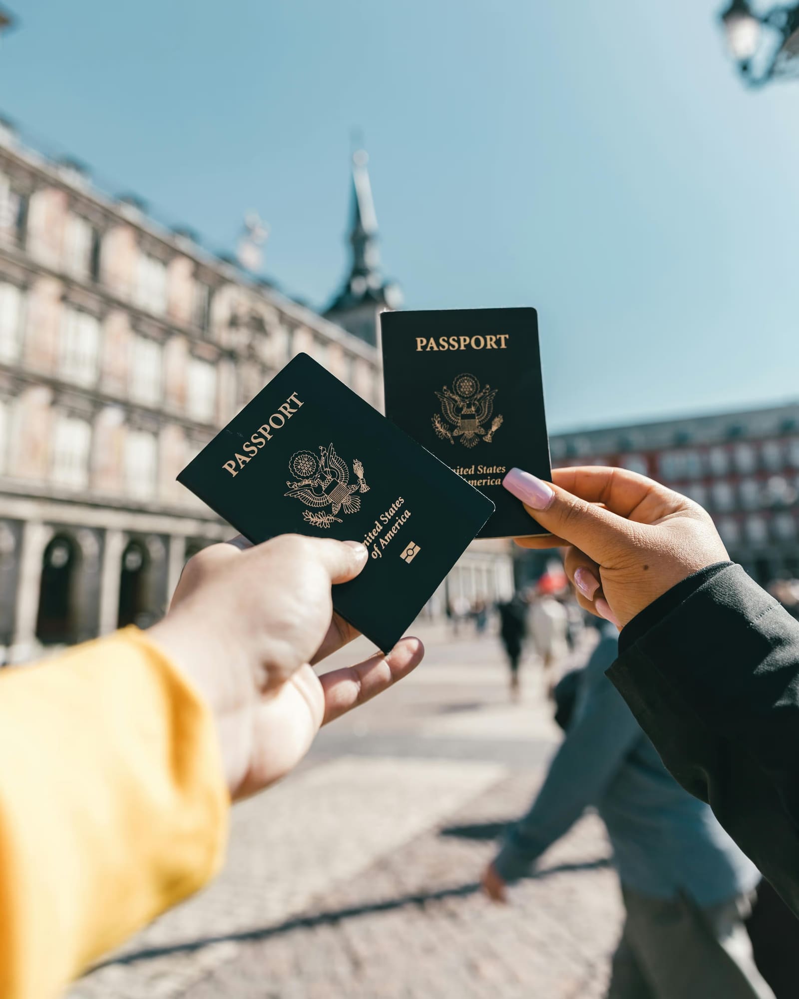 Hands holding two passports